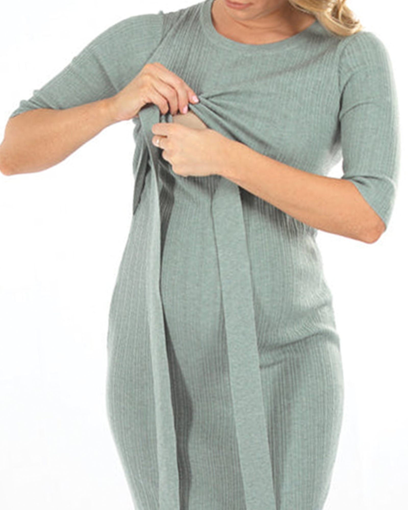 A woman in sage green angel maternity Annabella knit dress smiling & showing hidden nursing access, feed. (6594394259559)