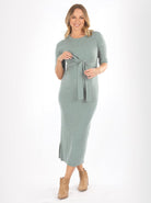 A woman in sage green angel maternity Annabella knit dress smiling, front (6594394259559)