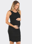 A woman in black bamboo maternity bodycon fitted dress, side (2194218287207)