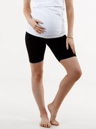 A woman in black maternity bike shorts, front (6535230947431)