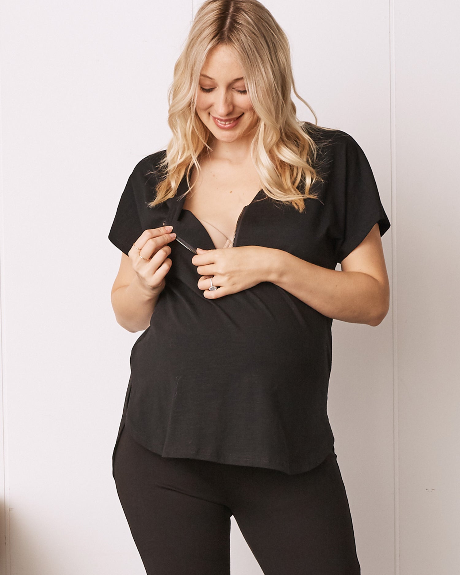 A Pregnant Woman in Black Short Sleeve Zip Front Maternity Work Blouse showing breastfeeding access (6711878254695)
