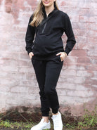 A woman in Calla navy black maternity tracksuit set, front2 (6647093657703)
