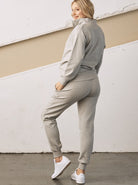 Side view - A pregnant woman in 2-Piece Calla zip front grey Maternity Tracksuit Set (6726621003870)