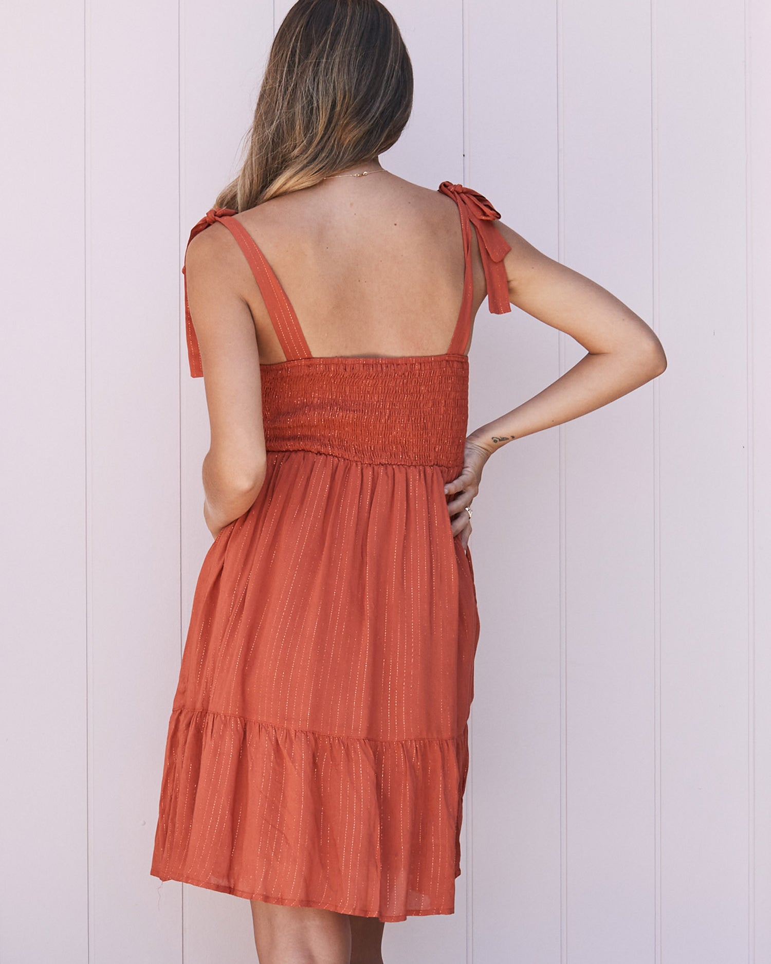 Back View - A pregnant Woman in Gold Thread Nursing Friendly Maternity Dress in Rust 